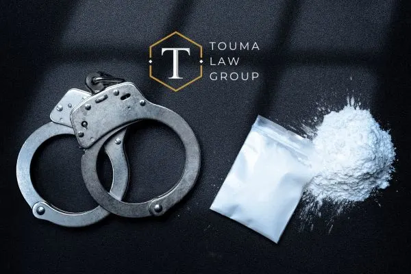 handcuffs on the left and baggies of white drugs on the right